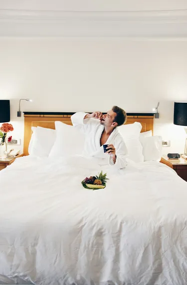 Guest in bathrobe enjoying room service