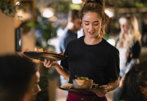 Waitress servicing guests